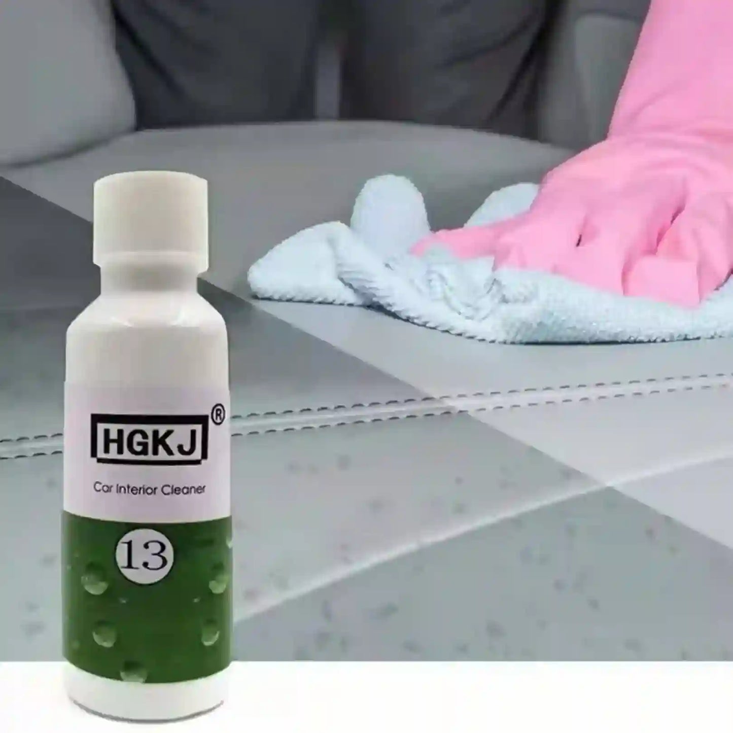 Bottle of HGKJ car interior cleaner with a gloved hand cleaning a car seat.