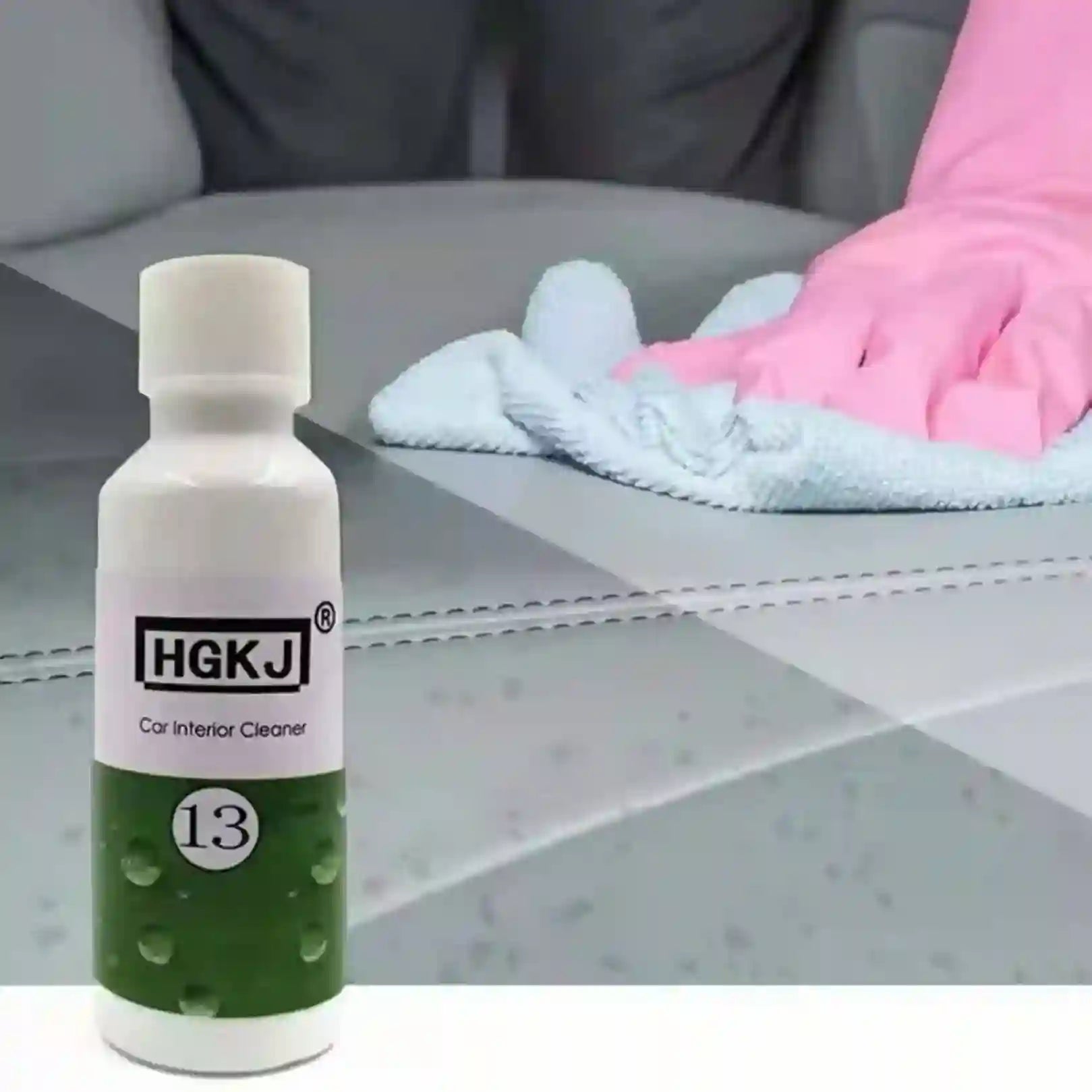 Bottle of HGKJ car interior cleaner with a gloved hand cleaning a car seat.