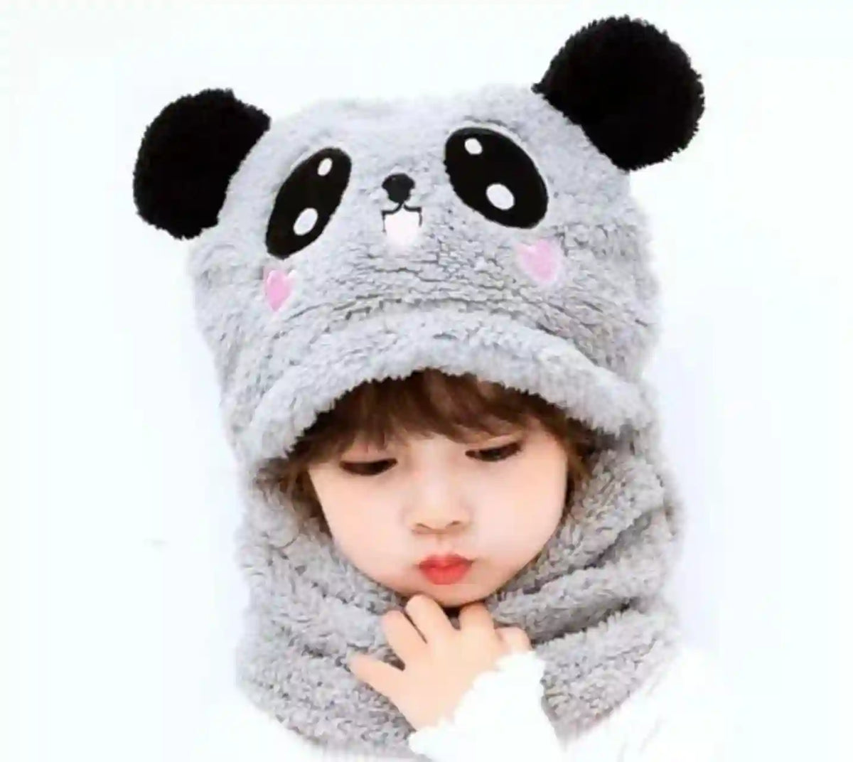 Child wearing a gray panda hat on a white background
