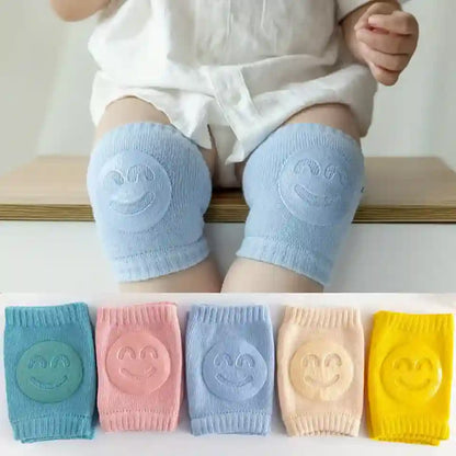 Baby wearing light blue knee pads with smiley face design, followed by a display of multiple knee pads in different colors.