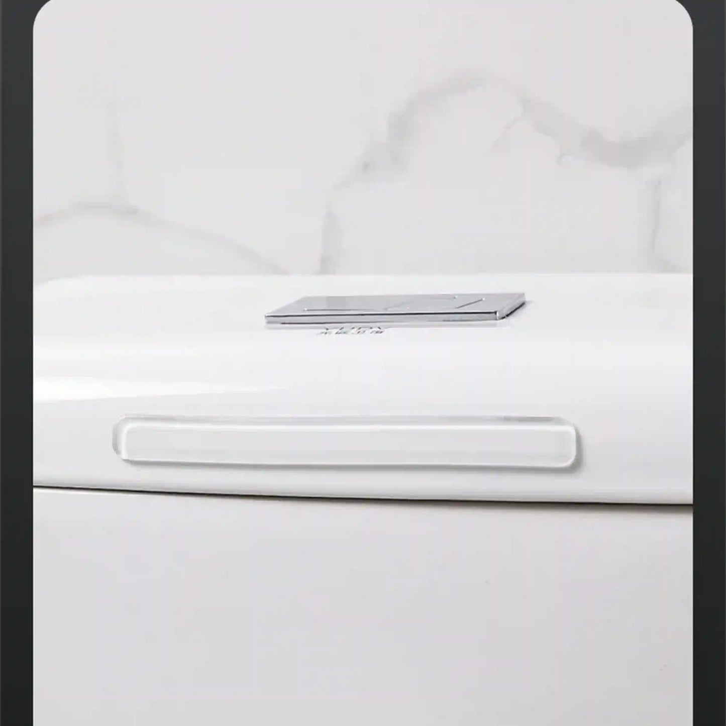 Close-up of a white appliance with a metallic handle on a light gray background