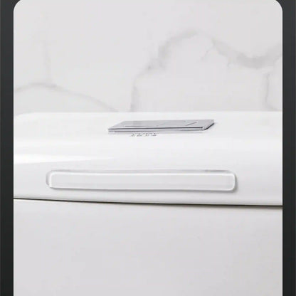 Close-up of a white appliance with a metallic handle on a light gray background