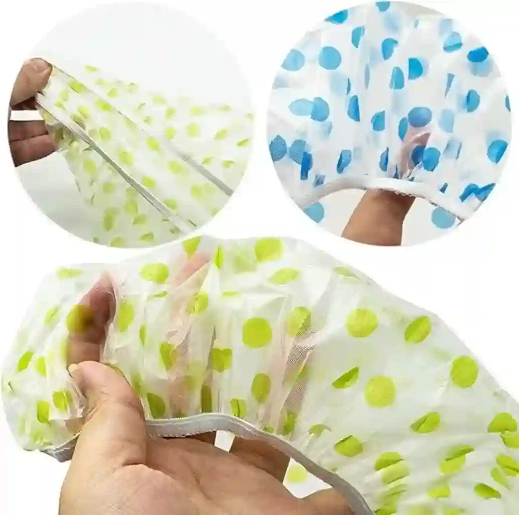 Polka dot shower caps in green and blue held by hands against a white background.