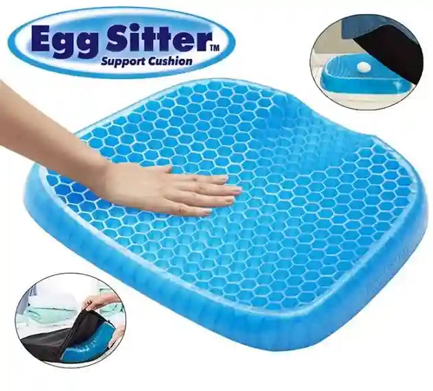 Blue Egg Sitter support cushion with honeycomb pattern, shown with a hand on top.