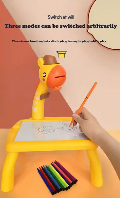 Yellow toy with a seat, drawing surface, and pencil holder on a pink background