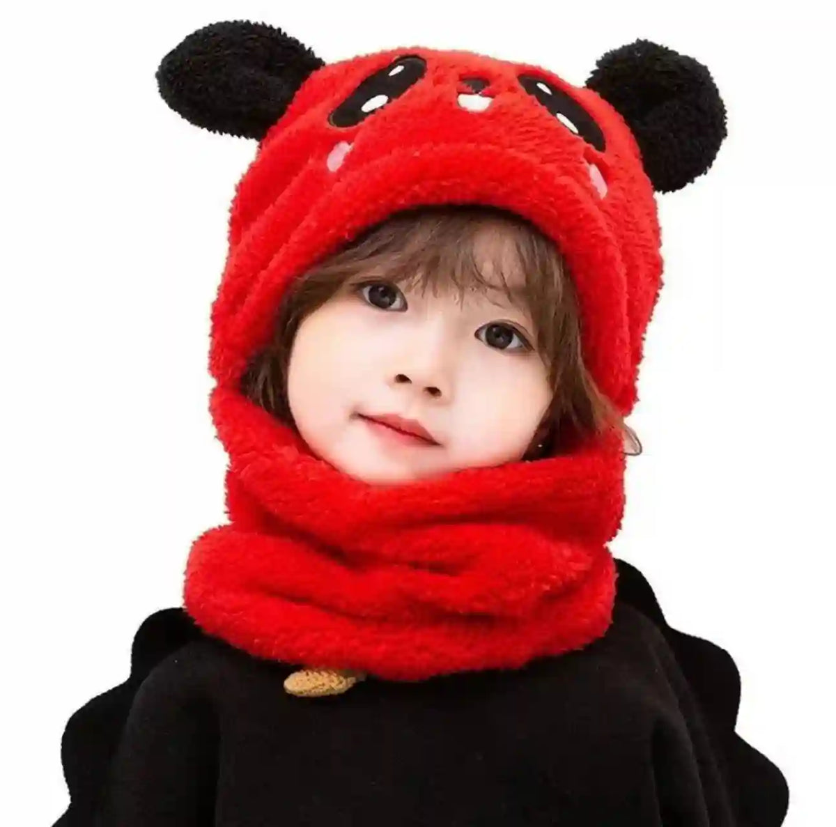 Child wearing a red hooded outfit with black ears on a white background