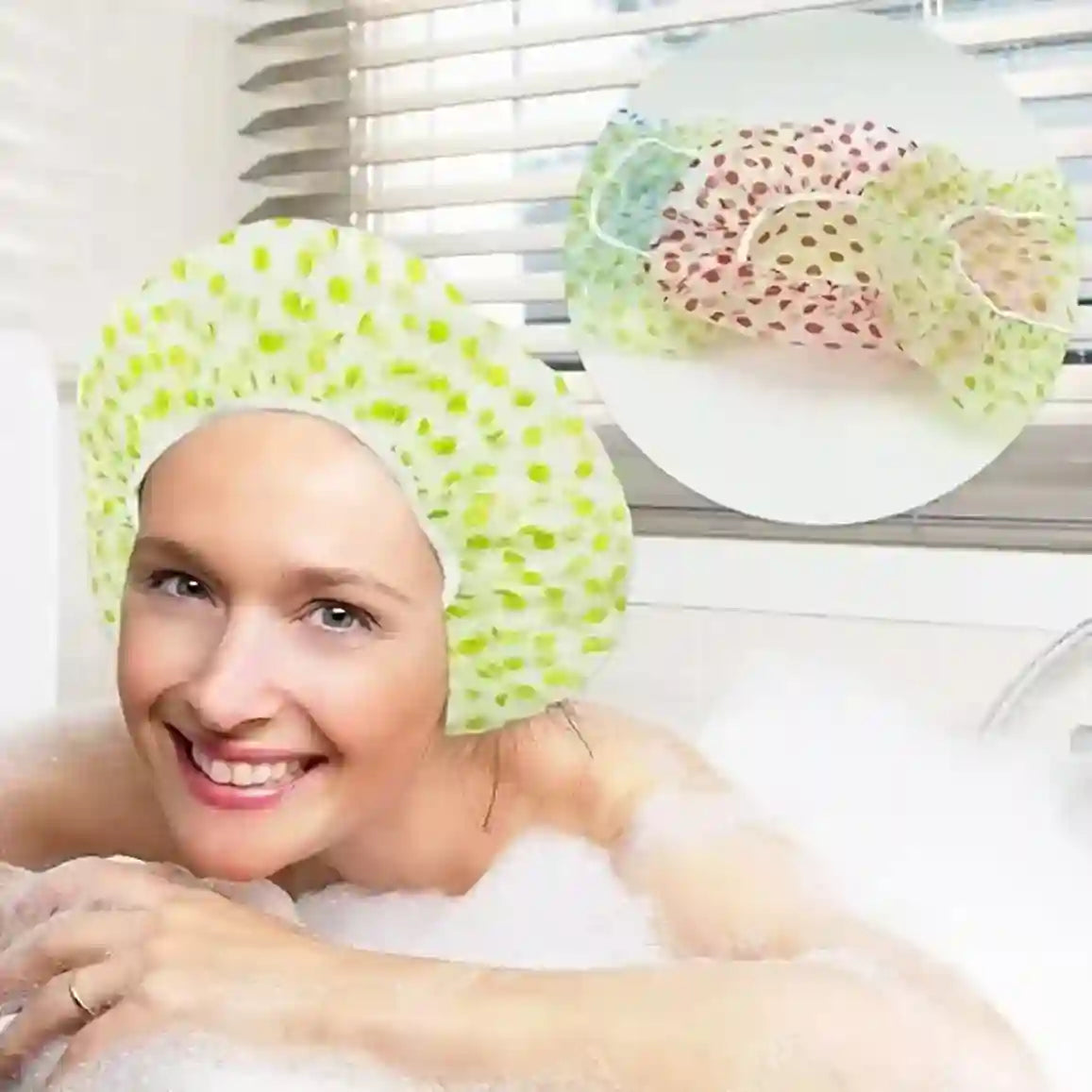 Woman in a bathtub wearing a green shower cap with polka dots, surrounded by bubbles.