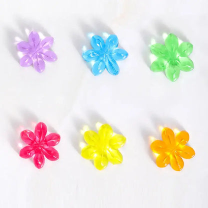 Set of six colorful flower-shaped objects on a white background