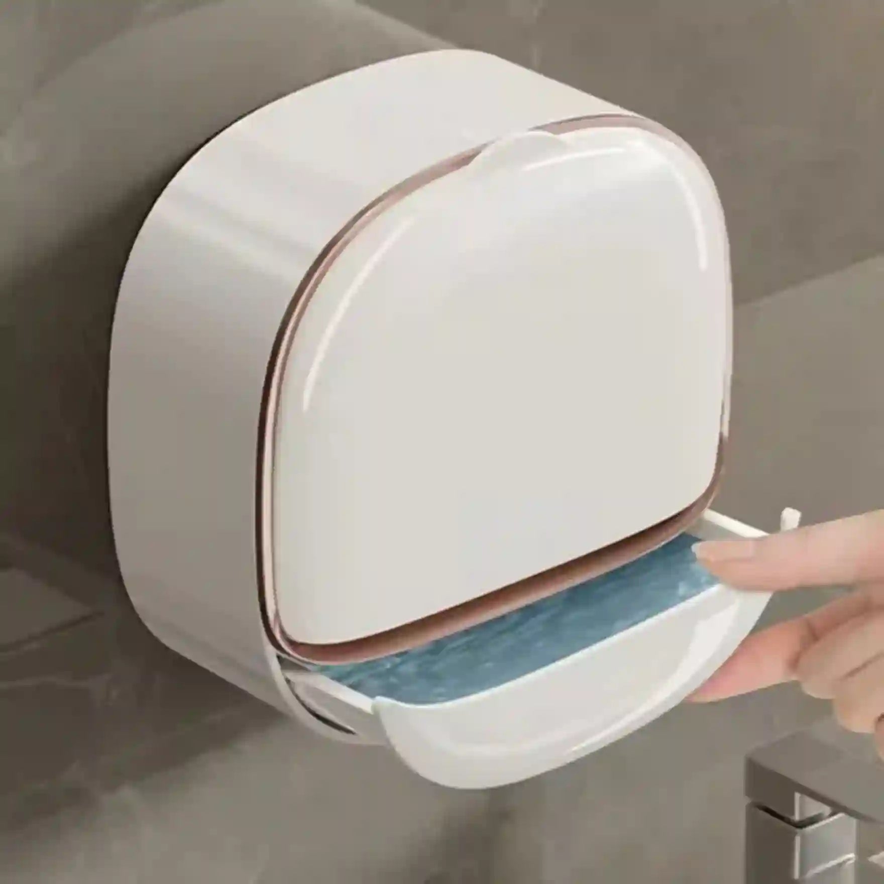 White wall-mounted trash can with a hand reaching to open it.