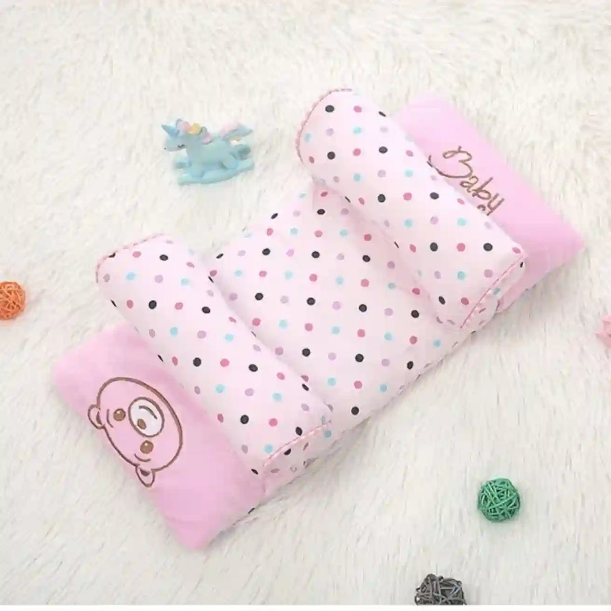 Pink baby blanket with polka dots and cartoon character on a white background