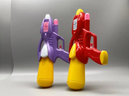 Two colorful toy water guns, one purple and yellow, one red and yellow, on a gray background.