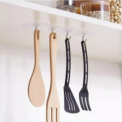 Set of kitchen utensils hanging under a cabinet with hooks.