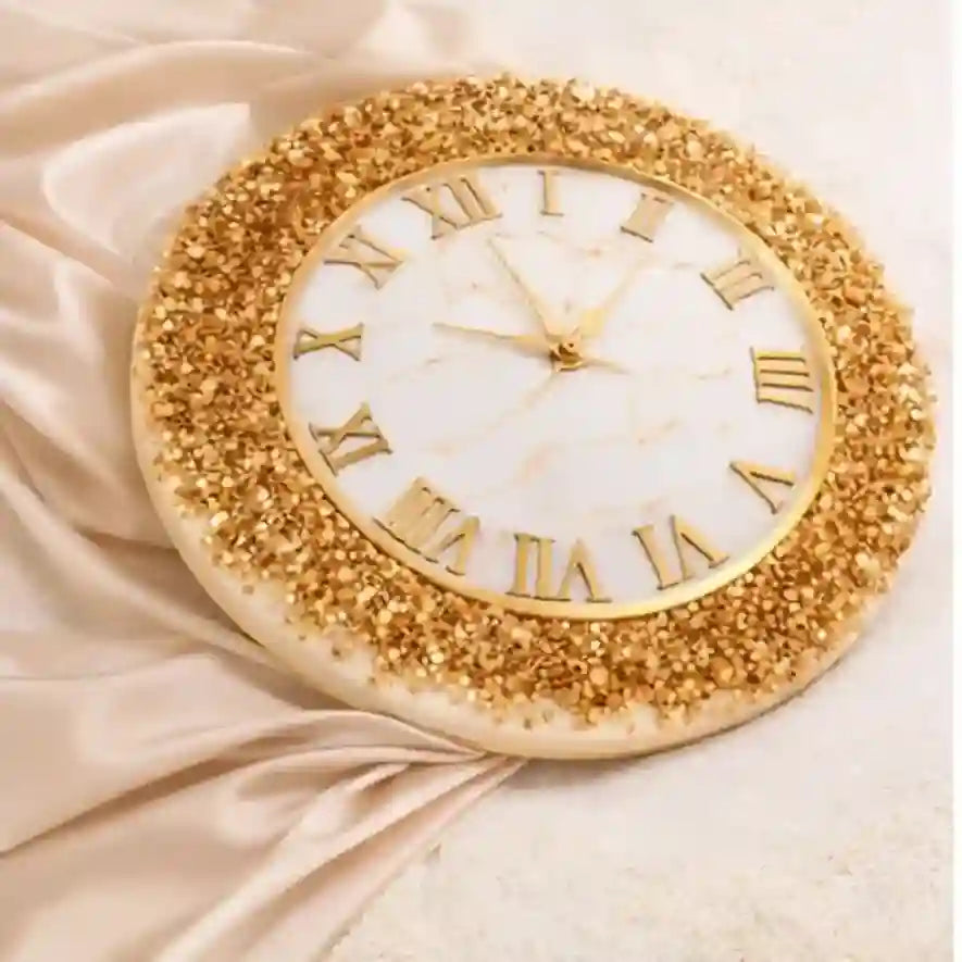 Decorative wall clock with gold glittery frame and Roman numeral markers on a beige fabric background