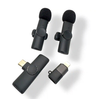 Set of black lapel microphones with connectors on a white background