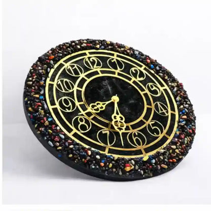 Decorative clock with gold hands and multicolored stone border on a white background