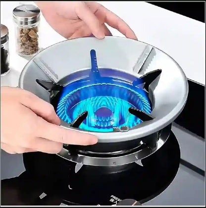 Gas stove burner with blue flame being adjusted by a hand on a white background