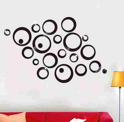 Black circular wall decal on a white wall with a red couch and yellow lamp in the foreground.