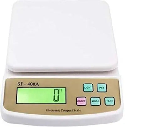 Digital compact scale with a white top and beige base on a white background
