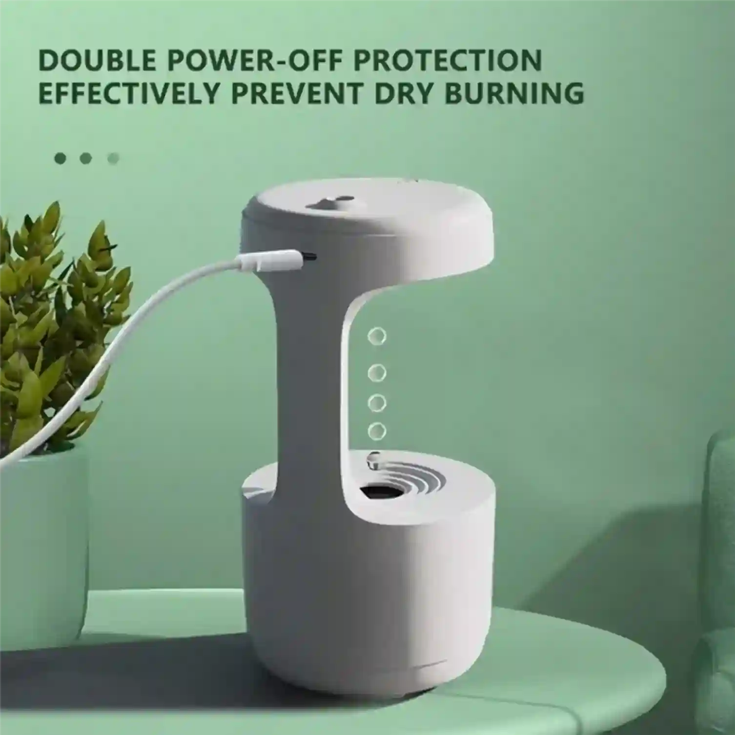 White electronic device with a cable on a green surface, featuring text about power-off protection.