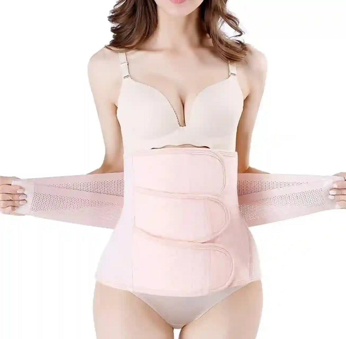 Woman wearing a beige body shaper against a white background
