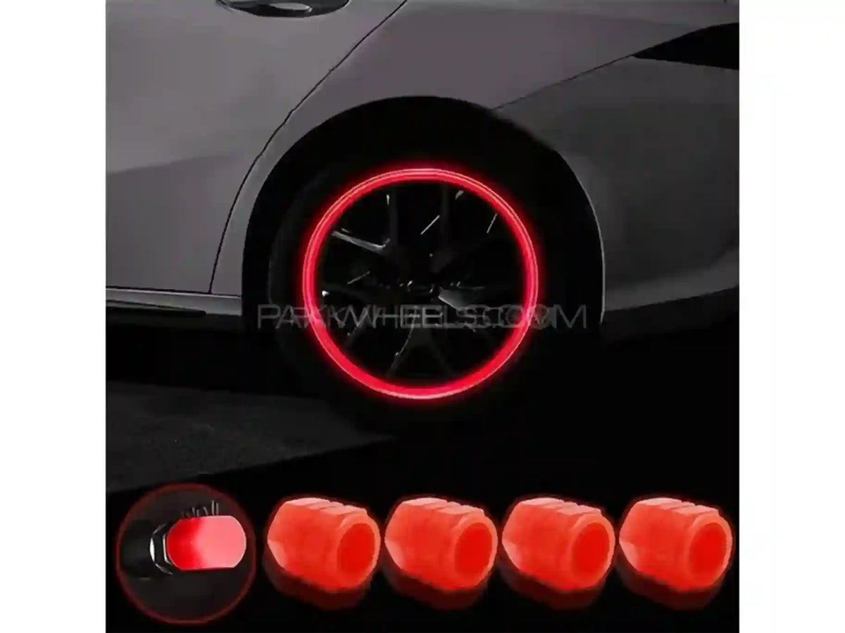 Car wheel with red rim and five red wheel covers displayed below.