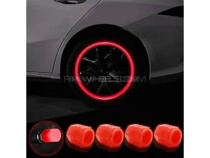 Car wheel with red rim and five red wheel covers displayed below.