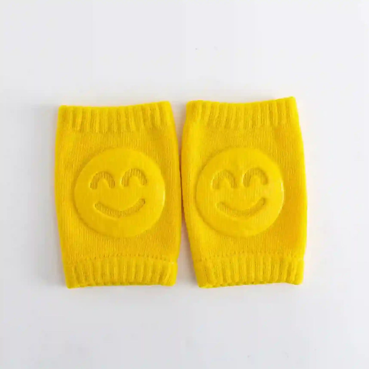 Pair of yellow knee pads with smiley face designs on a white background