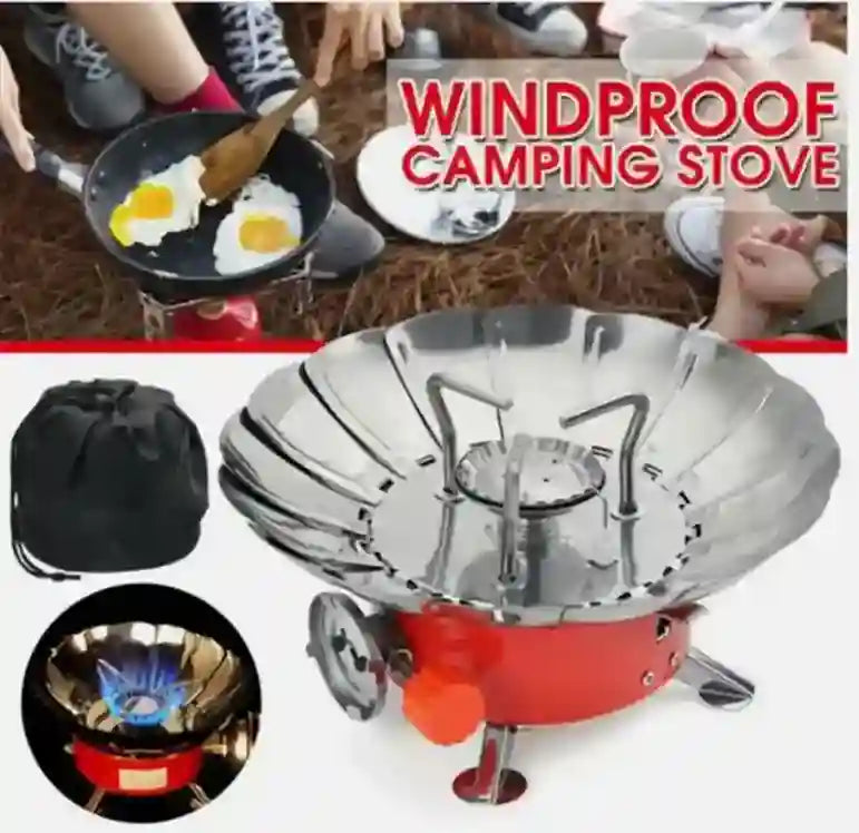 Windproof camping stove with cooking pan and flames, surrounded by people and food items.
