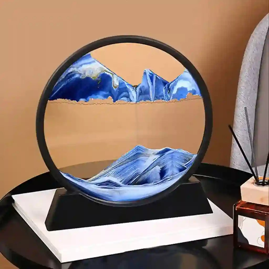 Decorative piece with blue mountain design on a black base against a beige wall.