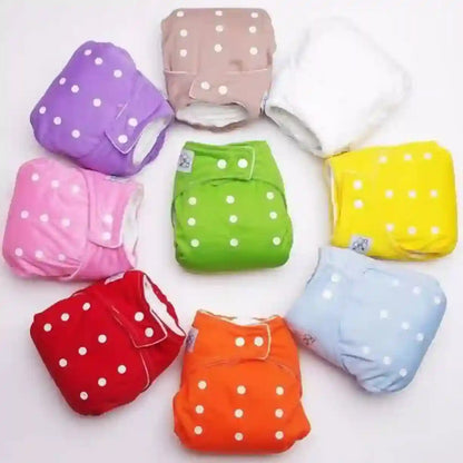 Colorful baby diapers with white polka dots on a white background