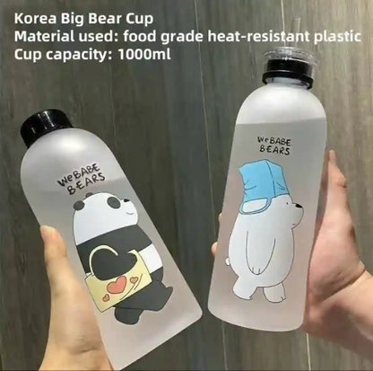 Two transparent water bottles with cartoon designs and text, held by a hand against a wooden surface.