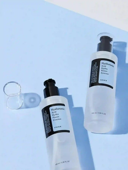 Two skincare bottles with labels on a light blue background