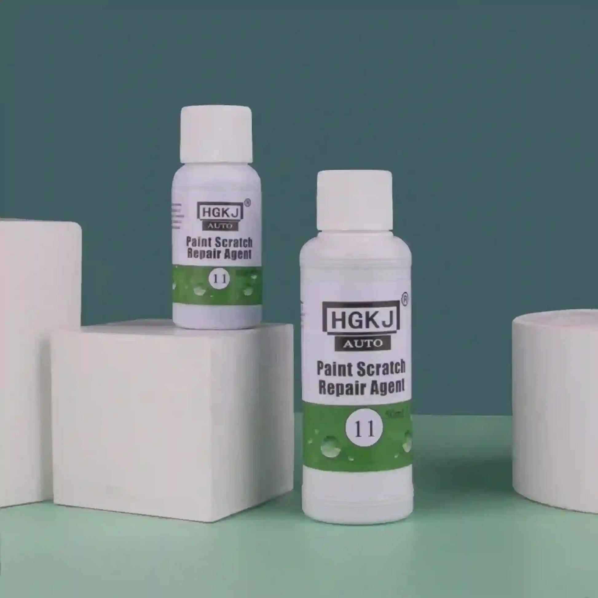 Two bottles of HGKJ AUTO Paint Scratch Repair Agent on a green and blue gradient background.