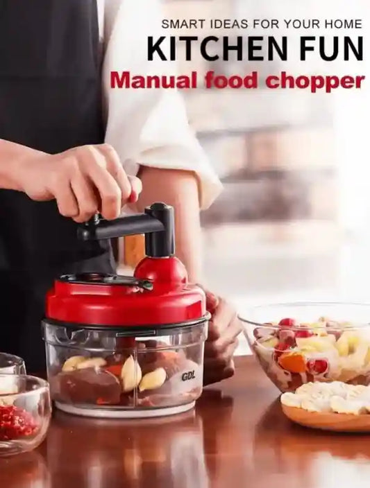 Manual food chopper being used with a kitchen setting in the background