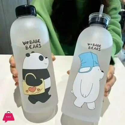 Two clear water bottles with cartoon bear designs held by a person wearing a green sweater.