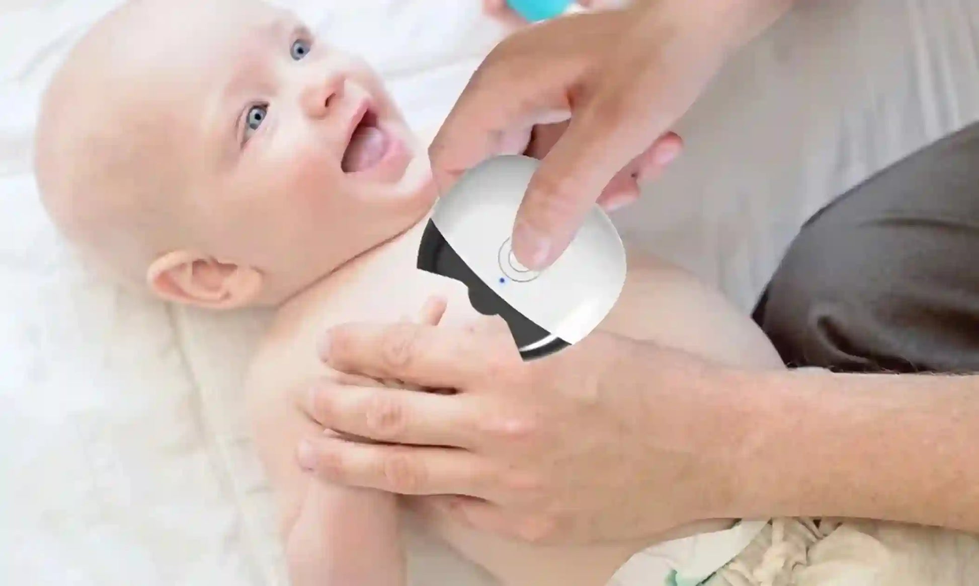 Baby with a diaper being checked by an adult's hand on a white background