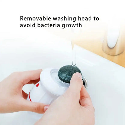 Hand holding a white device with a black cleaning head, text 'Removable washing head to avoid bacteria growth' on a light background.