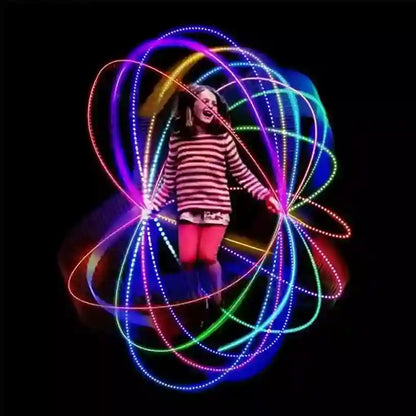 Person holding a colorful LED hoop with a black background