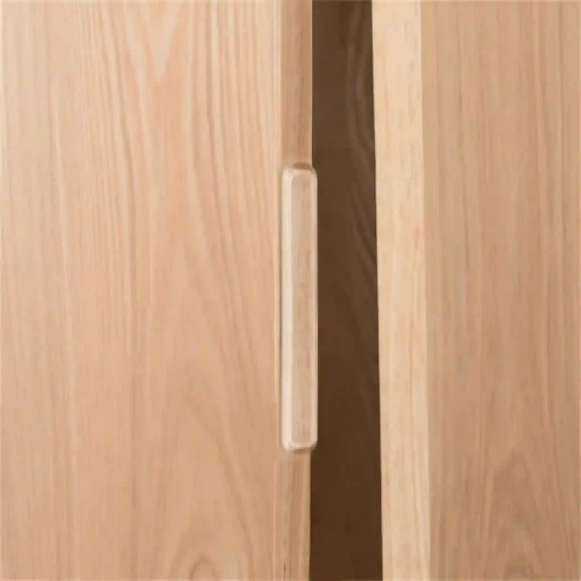 Close-up of a wooden cabinet with a handle