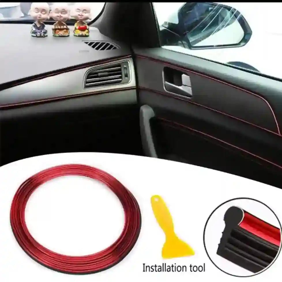 Car interior with red trim strip and installation tool on a white surface