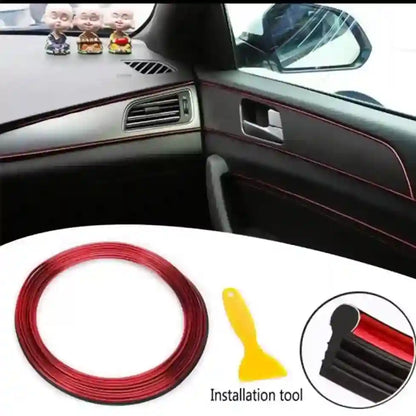 Car interior with red trim strip and installation tool on a white surface