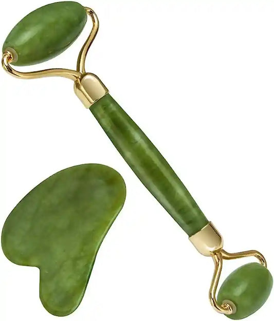 Green jade roller and gua sha tool on a white background