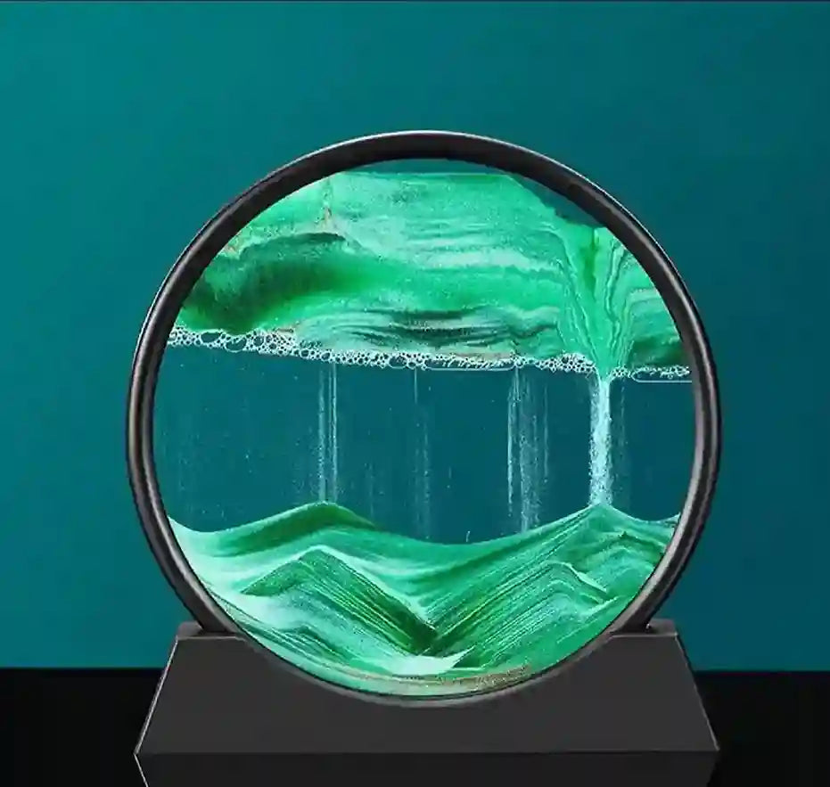 Green glass sculpture with mountain and water design on a black base against a teal background