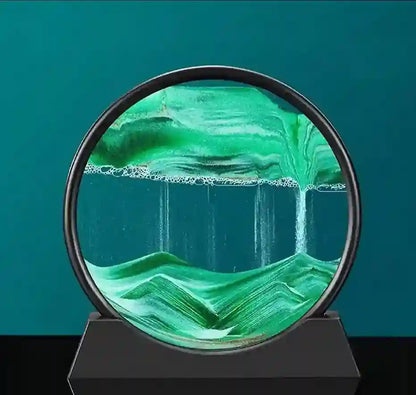Green glass sculpture with mountain and water design on a black base against a teal background