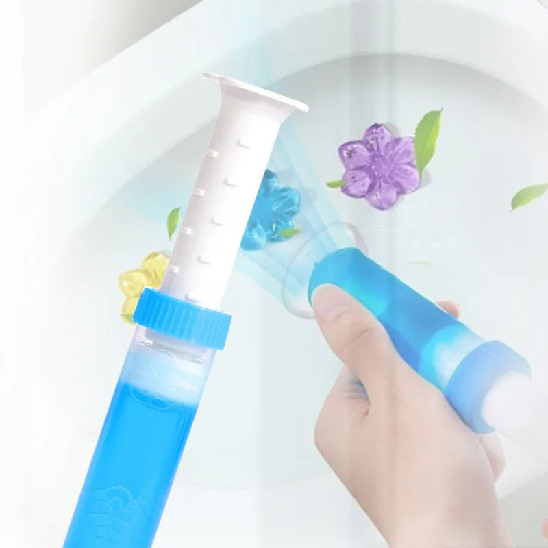 Hand holding a blue cleaning tool with floral design against a white background