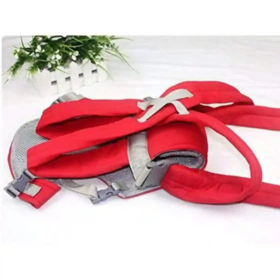 Red dog leash with gray clips on a white background
