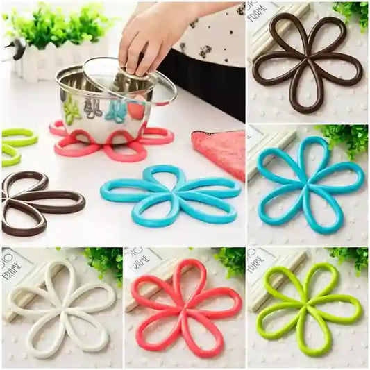Collage of flower-shaped silicone coasters in various colors on a white surface.