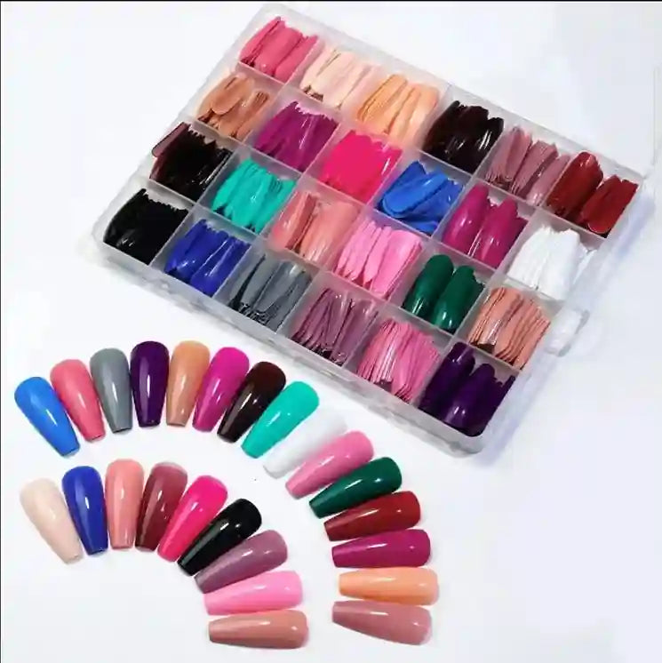 Assorted colorful nail extensions in a clear organizer on a white background