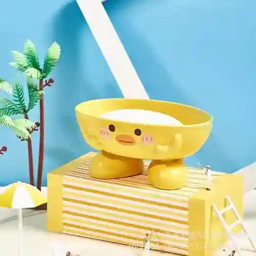 Yellow cartoon-like bowl with a face on a striped surface against a blue wall.