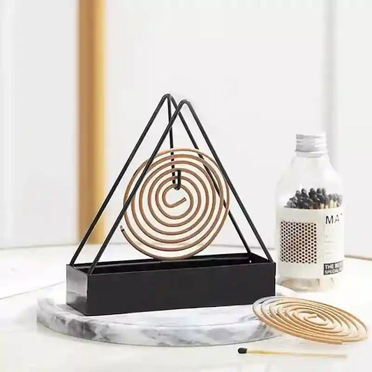 Triangular metal stand with wooden coils on a marble surface